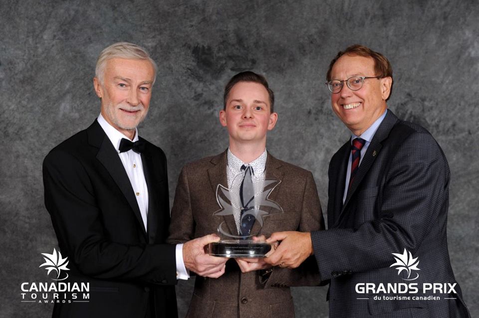 Bill Knowlton from Jonview Canada, Zach Vanasse from Outer Shores and Murray Rankin MP from Victoria accepting the Transat AT Sustainable Tourism Award for Outer Shores Expeditions at Tourism Industry Association of Canada Awards