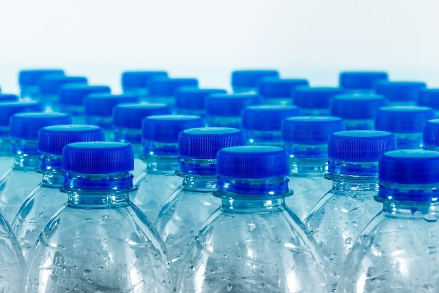 stock photo of clear plastic water bottles with blue caps