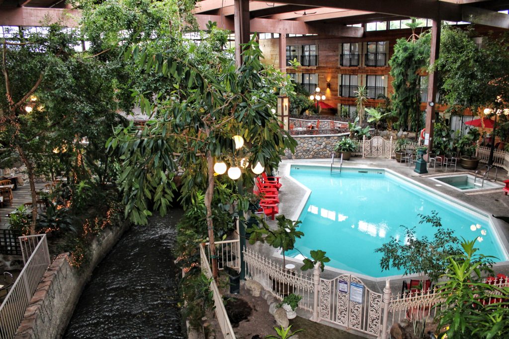 view of the garden atrium and pool at the Prestige Vernon Lodge in Vernon, North Okanagan, British Columbia.