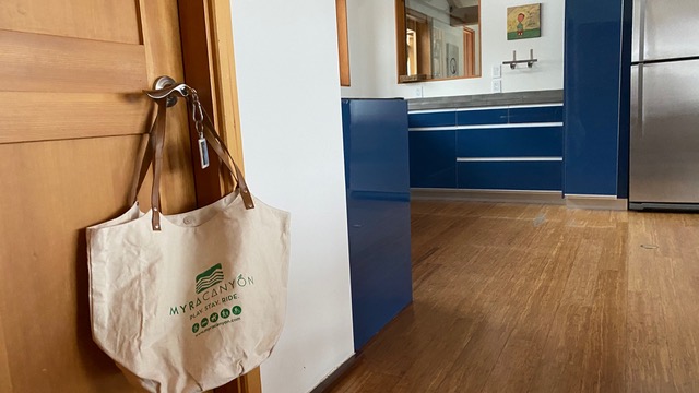 photo of a reusable cloth shopping bag hanging from a door to a suite at Myra Canyon Ranch in Kelowna, British Columbia, Canada.