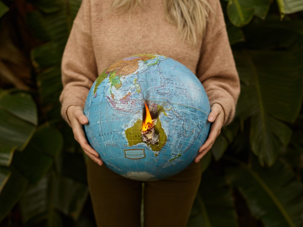 a person holding a globe between their hands